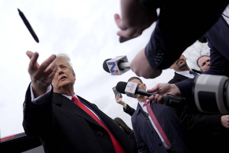 Republican presidential candidate former President Donald Trump tosses a pen as he addresses members of the press during a campaign stop in Londonderry, N.H., Tuesday, Jan. 23, 2024. (AP Photo/Matt Rourke)