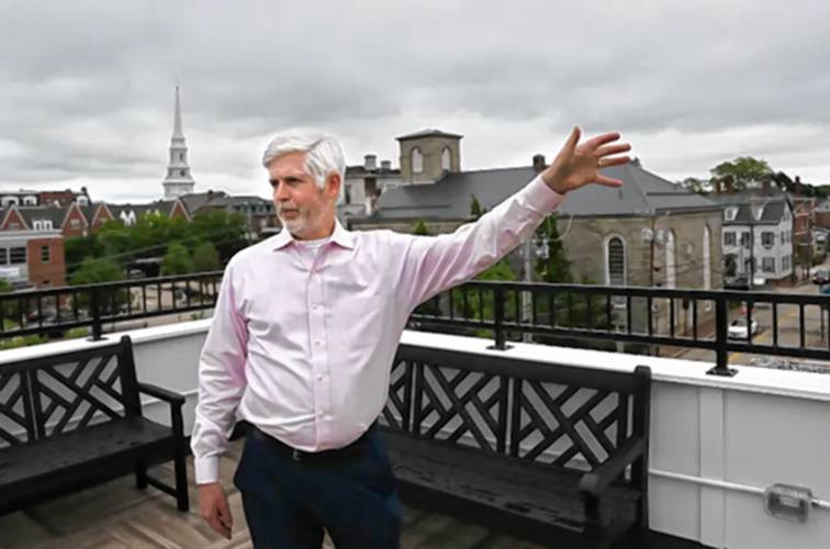 Portsmouth Housing Authority Executive Director Craig Welch shows off a deck at the new Ruth Lewin Griffin Place in June 2022.