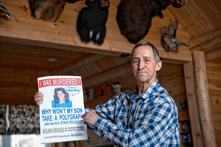 Ken Dionne holds up a flier he made at his New Boston home, wondering if the killer of his sister, Bobbie, will be caught.