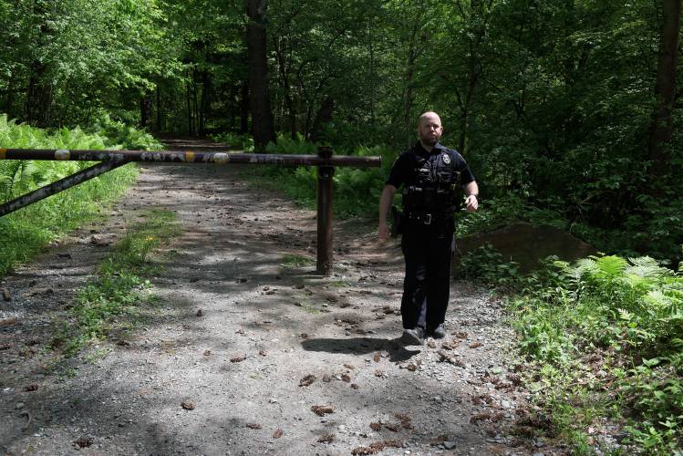 Lebanon Police Officer Eric Hunter returns to his vehicle after assisting a Dartmouth Hitchcock Advanced Response Team helicopter search from the ground for missing West Lebanon resident Kexin Cai, 26, at the Boston Lot on Monday, May 20, 2024. Fellow members of Cai's graduate program in the Department of Psychological and Brain Sciences at Dartmouth College were also searching the conservation area on foot on Monday. (Valley News - James M. Patterson) Copyright Valley News. May not be reprinted or used online without permission. Send requests to permission@vnews.com.