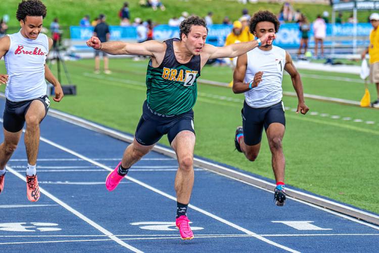 Bishop Brady’s Josh Gentchos (center) leans across the finish line to finish second in the 100-meter dash finals at the New England track and field championships at the University of New Hampshire on Saturday. Gentchos clocked a 10.68 second, breaking the previous state record of 10.73 seconds.