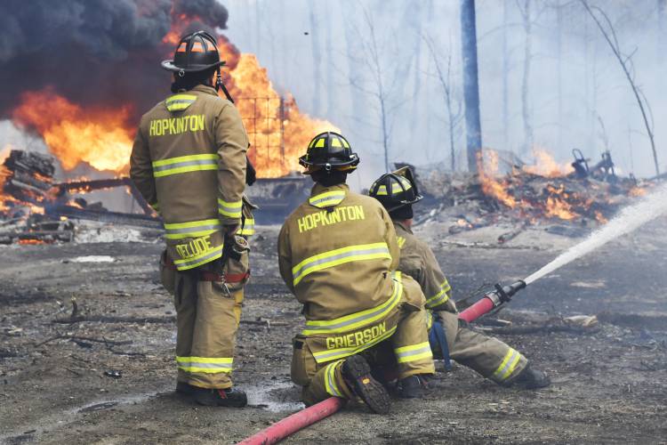 A fire at 100 Chase Farm Road in Hopkinton on Monday afternoon drew firefighters from around the area as flames spread from a garage to surrounding brush and fields.