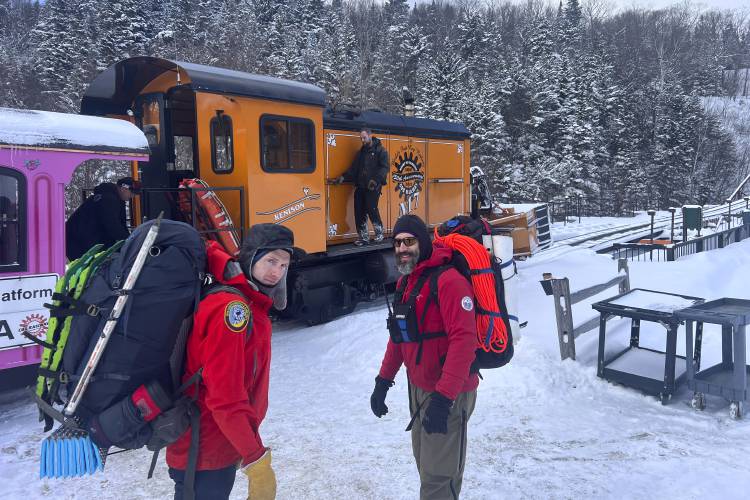 In this image provided by New Hampshire Fish and Game, New Hampshire Fish and Game conservation officer Levi Frye, left, and Jeremy Broughton, from Androscoggin Valley Search and Rescue, prepare to head out on a rescue mission at the Cog Railway base station, Saturday, Feb. 17, 2024, in Mount Washington, N.H. A team of rescuers used the Cog Railway to shave off time but it still took more than 10 hours to save a hiker in conditions that included sustained winds topping 90 mph (145...