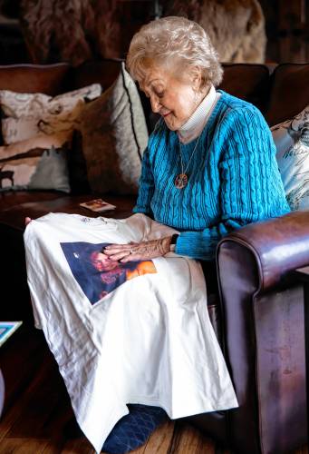 Maddie Dionne touches her daughter, Bobbieâs face on a tee shirt she made at her sonâs home in New Boston.