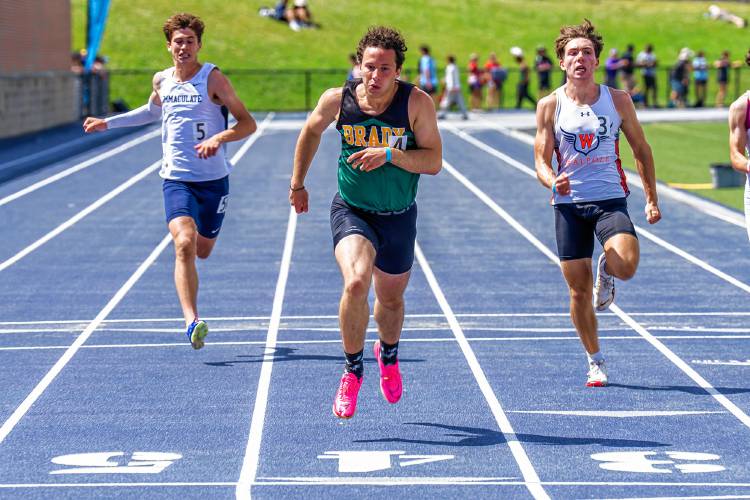 Bishop Brady’s Josh Gentchos (center) crosses the finish line to finish second in the 200 at the New England track and field championships at the University of New Hampshire on Saturday.