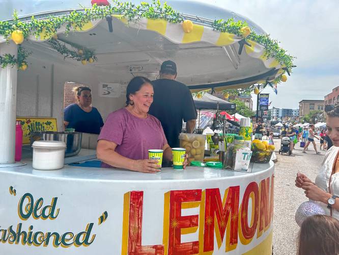 Charleen Nikias lends a hand at her niece Sandy Ryan's lemonade stand, which is hard to miss with its garland of lemons.