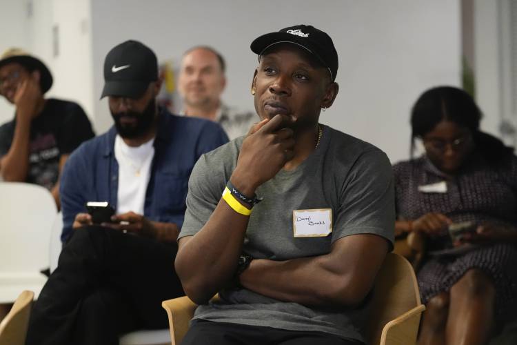 Darryl Banks, center, reacts while watching the first general election debate of the 2024 season, between President Joe Biden and Republican presidential candidate former President Donald Trump at a watch party organized by the Miami Freedom Project at the Center for Black Innovation in Overtown, Miami, Thursday, June 27, 2024. (AP Photo/Rebecca Blackwell)