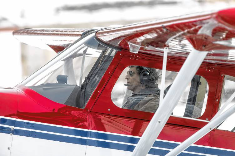 A pilot gets ready to take off at the Alton Bay airport on Sunday, February 2, 2025. Planes took off and landed all weekend in front of big crowds.