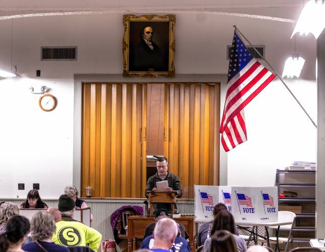 Salisbury Town Moderator David Hostetler reads the first warrant article at Town Hall on Tuesday. The article passed, with one amendment, by a voice count.