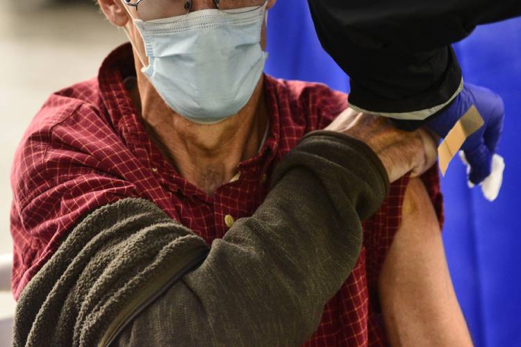 A man receives a flu shot in Brattleboro, Vt., on Tuesday, Oct. 26, 2021. A man receives a flu shot in Brattleboro, Vt., on Tuesday, Oct. 26, 2021.