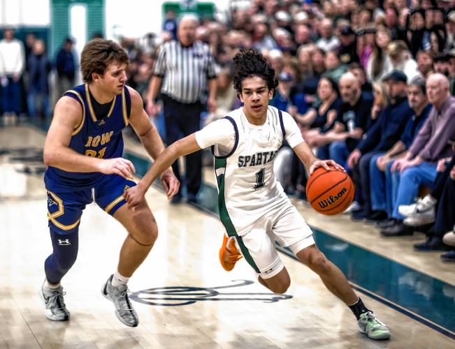 Pembroke guard Evan Berkeley dribbles past Bow forward Peyton Larrabee during the second half of the D-II quarterfinals on March 7.