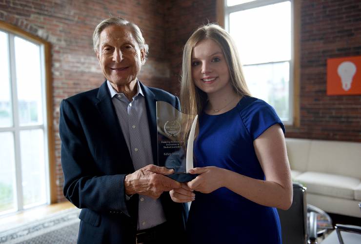 Howard Brodsky and first-place prize winner Kelsey Sweet pose with Sweet's prize.