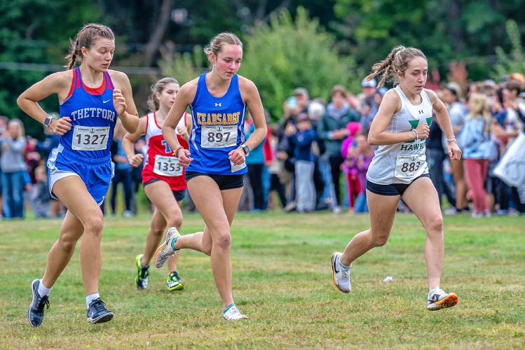Kearsarge’s Molly Ellison (center) and Hopkinton’s Maddy Lane (right) head to the front of the pack early in the Girls’ Small School Race at the 48th Manchester Invitational at Derryfield Park on Sept. 23. Lane finished fifth and Ellison finished ninth out of more than 200 runners. Ellison and Lane will battle for the Division III individual crown at Derryfield Park on Saturday.