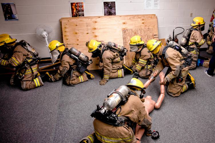 LEFT: CRTC firefighter students work through the obstacle course on Thursday at Concord High School.