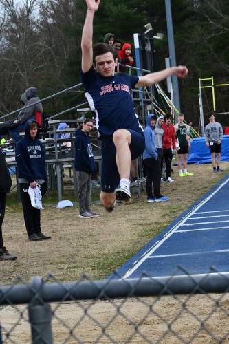 John Stark’s Rio Calle takes flight in the boys’ long jump at the Pelham Invitational on Saturday. Calle won the event with a leap of 20 feet, 2 inches, and was second in the 200 as the Generals took second out of 24 teams.