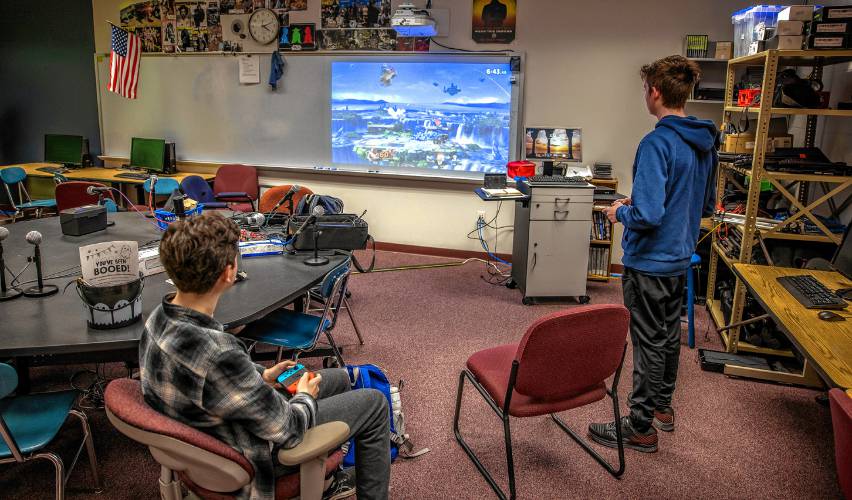 Bow players Carter Monroe, left, and  junior Matthew Kropp play a team from Texas at their epsorts match at the Bow High library Wednesday.