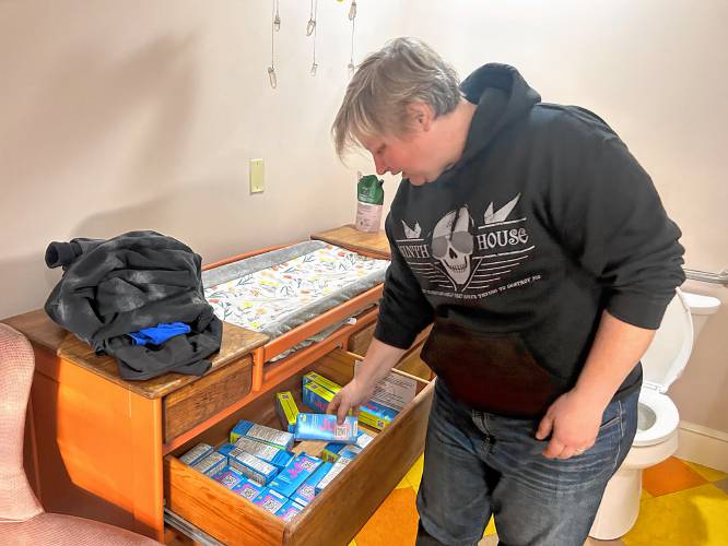 Alyssa McClary, co-owner of Penumbra in downtown Concord checks the drawers storing emergency contraceptive pills under the changing table in the store bathroom