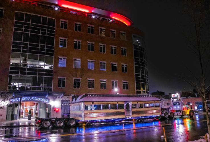  The main portion of the diner sits on a low load trailer in front of Hotel Concord building as it waits to be moved into place in Artis Alley in early Wednesday morning.