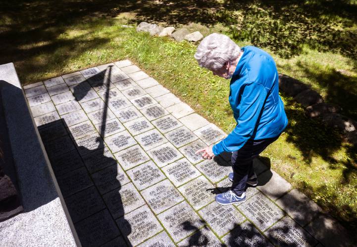 Marguerite Moffet pauses at the United States Marine Corps at the NH Veterans Cemetery in Boscawen on Tuesday, May 27, 2025. Her son,  John, has a tile at the memorial and is buried at the cemetery