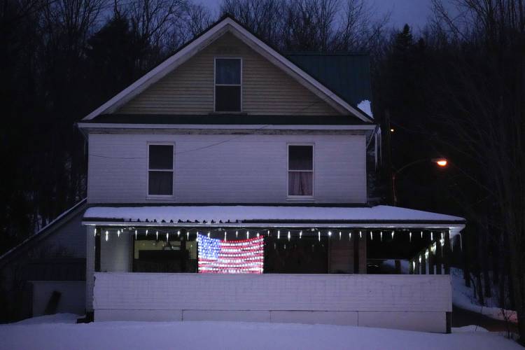 A home with patriotic spirit is decorated near the town's polling place on the morning of the presidential primary election, Tuesday, Jan. 23, 2024, in the Groveton village of Northumberland, N.H. (AP Photo/Robert F. Bukaty)