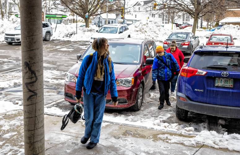 Amber MacQuarrie walks in the KaiPod Learning Center in Manchester with her children, Olive and Ethan,  on Feb. 21.
