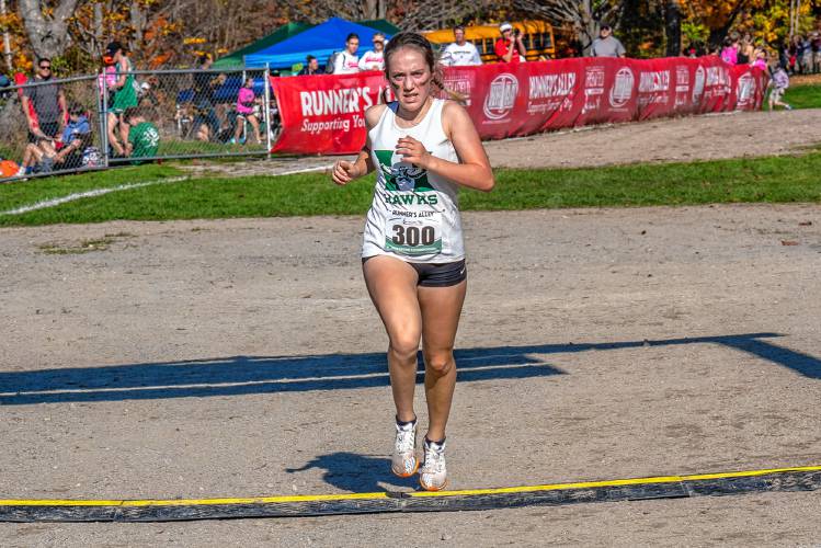 Hopkinton’s Maddy Lane crosses the finish line to become the NHIAA Division III girls’ state champion at Derryfield Park in Manchester on Saturday. Lane finished the race in 19 minutes, 31 seconds to lead the Hawks to second place as a team.