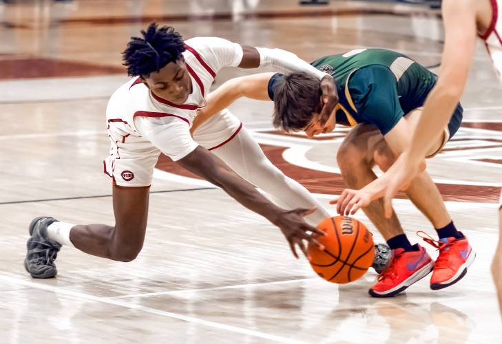 Concord guard Japhet Nduwayo battles Bishop Guertin guard Connor McGowan for the ball during the first half on Friday night.