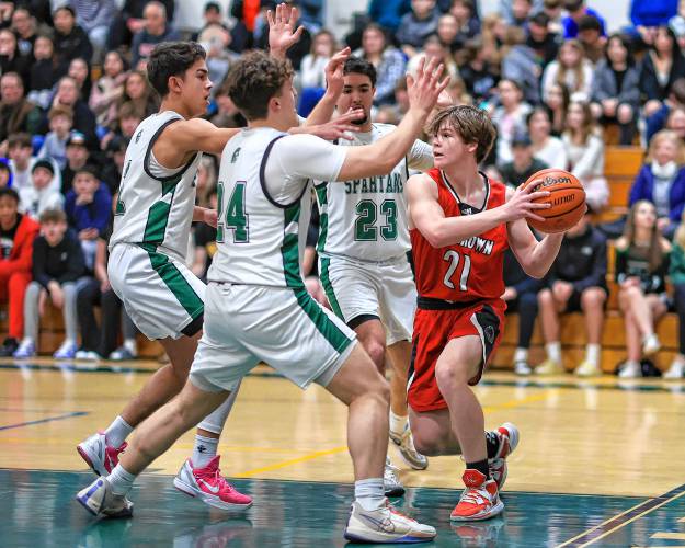 Pembroke’s Mason Gagne (24), Evan Berkeley (1) and Zach Al-Shawafi (23) surround Coe-Brown’s Ryan Kouchoukos during Monday night’s game.