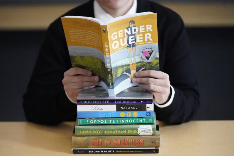 Amanda Darrow, director of youth, family and education programs at the Utah Pride Center, poses with books that have been the subject of complaints from parents in recent weeks on Thursday, Dec. 16, 2021, in Salt Lake City. Amanda Darrow, director of youth, family and education programs at the Utah Pride Center, poses with books that have been the subject of complaints from parents in recent weeks on Thursday, Dec. 16, 2021, in Salt Lake City.