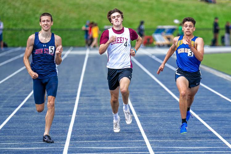 John Stark’s Logan Montgomery (left) and Concord Christian’s Rolen Sanderson (right) compete in the 400 at the New England track and field championships at the University of New Hampshire on Saturday.