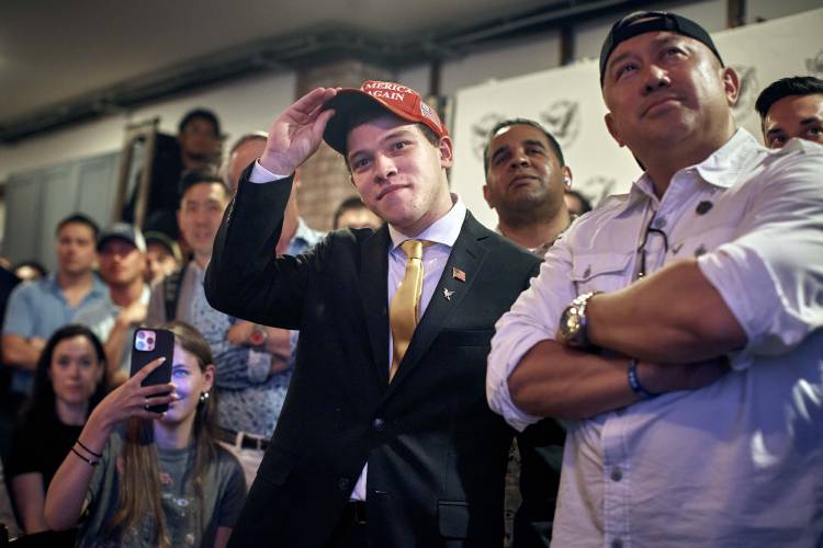 Trump supporter, Lucas Federico, 21 years old, from New York, center, watches the debate during the Young Republicans' Presidential debate watch party on Thursday, June 27, 2024, in New York as President Joe Biden faces former President Donald Trump during the first Presidential debate ahead of the 2024 elections. (AP Photo/Andres Kudacki)
