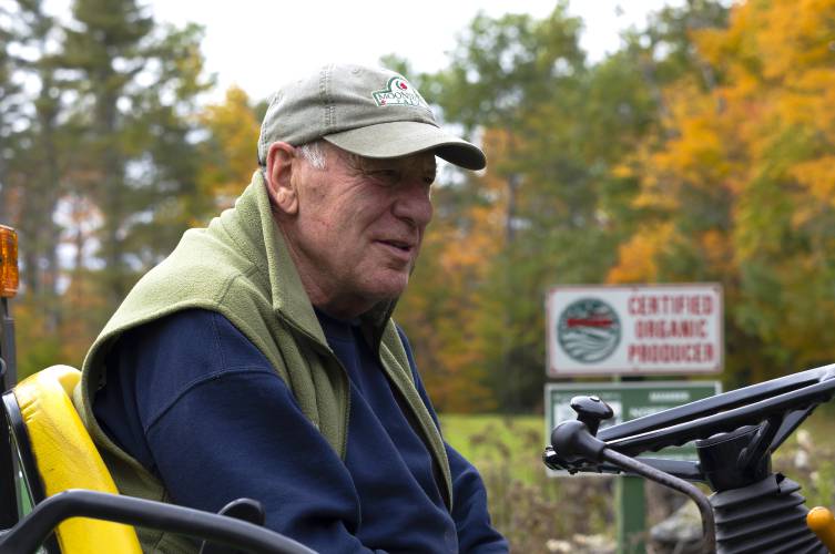 Dan Wolf of Newbury on his tractor in a field that he grows organic hay as well as organic eggs on 200 acres on Friday, October 15, 2021.