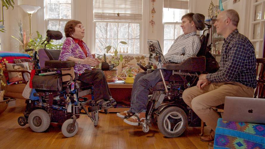 Judy Heumann (left) being interviewed by Samuel Habib (right), next to his co-director and father, Dan Habib, in Feb. 2020. Heumann, a pioneer in disability rights advocacy, died in March 2023.