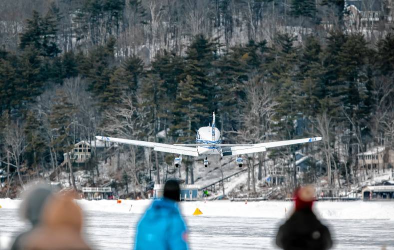 Visitors watch a plane takes off at the Alton Bay airport on Sunday, February 2, 2025. The ice must be at least a foot thick on Lake Winnipesaukee at the bay and the runway is a minimum of 2, 600 feet long and at least 100 feet wide.