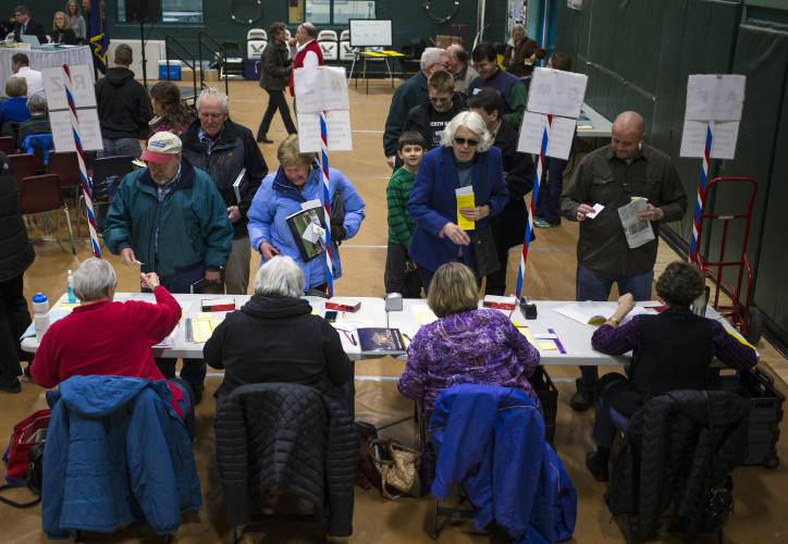 The crowd check in at the Hopkinton town meeting Saturday, March 18, 2017 at the high school gym.