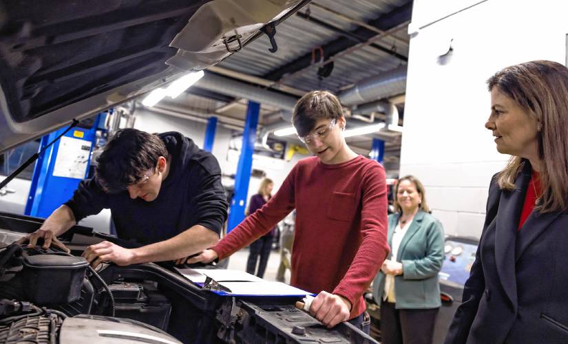 Gov. Kelly Ayotte talks  CRTC Auto mechanic students James Bemnert (center) and Dalton Bornstin at Concord High School as she gets a tour of all the programs at the school on Thursday, March 6.