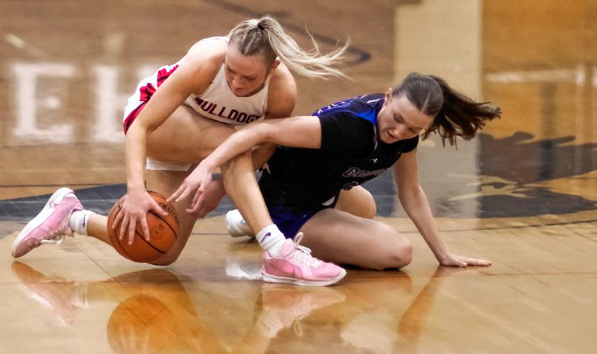 Concord Christian guard Lilli Carlile (right) battles for the ball with Bedford guard Sarah Muir at midcourt during the first half of the Division I semifinal at Exeter High School on Monday. Concord Christian lost to undefeated Bedford, 58-34.