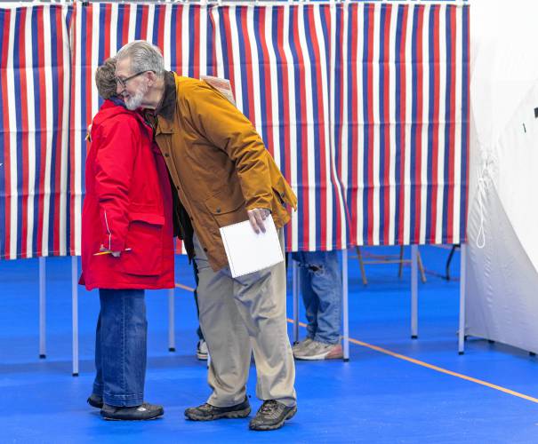 Concord Mayor Byron Champlin gets a hug from a fellow Primary voter at Ward 4 at the Green Street Community Center on Tuesday, January 23, 2024.