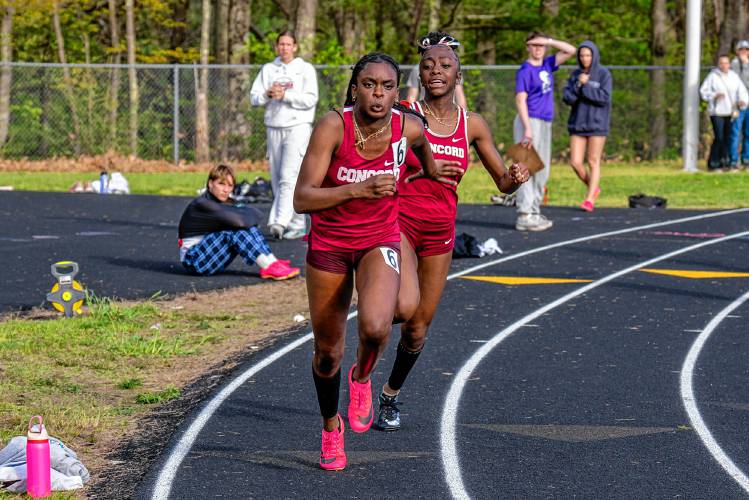 Concord’s Ballay Conteh (back) hands off to anchor Grace Saysaw (front) for the final leg of the 4x100-meter relay at the Merrimack Invitational on Thursday. Conteh, Saysaw, Chelsea Toenah and Ella Goulas set the school record in 49.89 seconds.