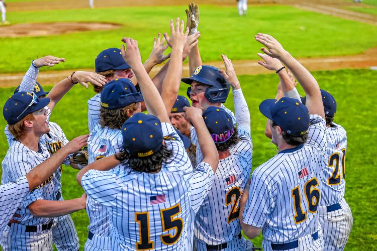 Bow baseball celebrates around Colby Smith after Smith scored a run in the Falcons' 10-2 win over John Stark in the D-II semifinals on Wednesday, June 5, 2024.