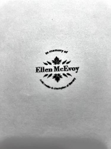 Mary McEvoy-Barrett made a stamp in her sister Ellen McEvoy’s honor to mark books she offers for others to read.