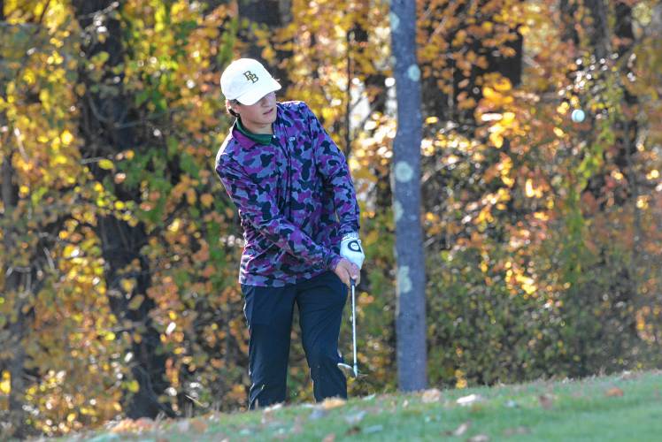 Bishop Brady’s Aiden Boule takes a chip shot at the Division III golf championship on Thursday at Rochester Country Club. Boule tied for the top of the leaderboard, lifting Brady to its first team title since 2005.