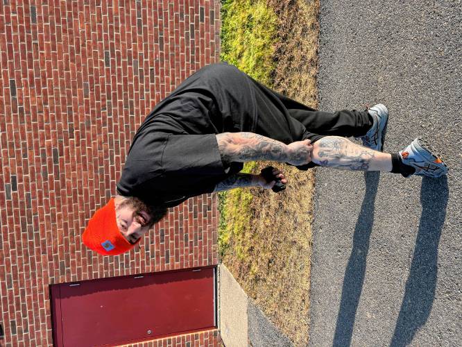 Pittsfield resident Chris Shaw shows off his tattoo of Donald Trump outside the polls on Tuesday.