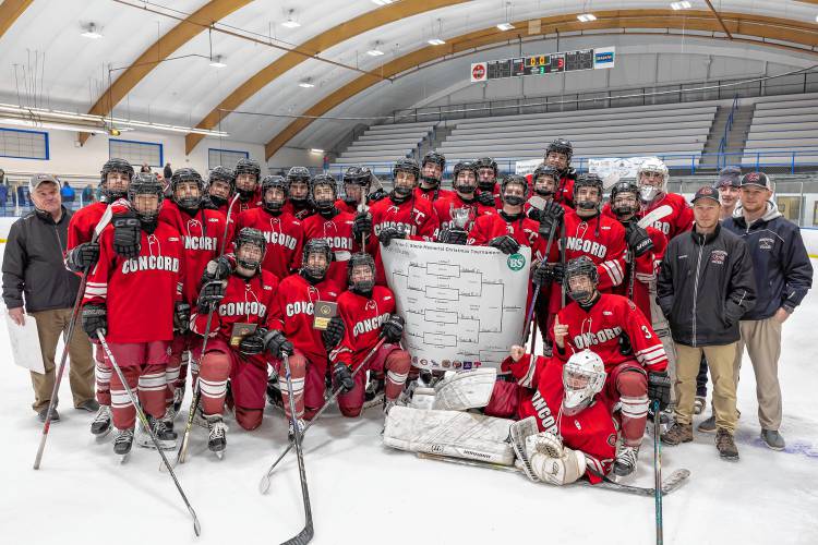 The Concord High School Crimson Tide boys’ hockey team poses the Brian C. Stone Memorial Christmas Tournament championship trophy. Concord beat Exeter, 3-1, in the final on Saturday night.