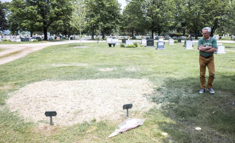 Bill Byrne looks over the burial plots for his daughter, Julia, and grandson, Blake at Blossom Hill Cemetery in Concord on Wednesday, June 4, 2025. Byrne’s daughter, Julia, 26, took the life of her 3-year-old son, Blake, and then her own.