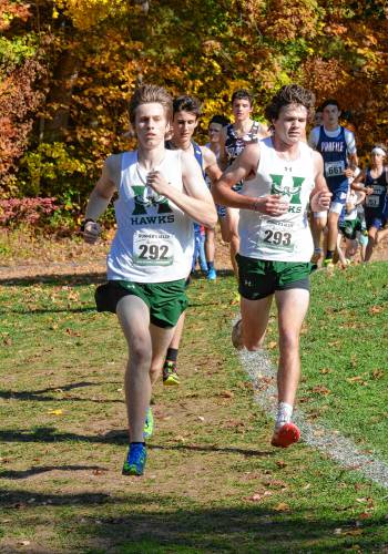 Matt Clarner (left) and Ben Daniels (right) lead a group of runners at the NHIAA Division III state championship at Derryfield Park in Manchester on Saturday. Clarner finished sixth and Daniels came in seventh to lead Hopkinton boys’ team to the state championship, the Hawks’ first crown since 2012.