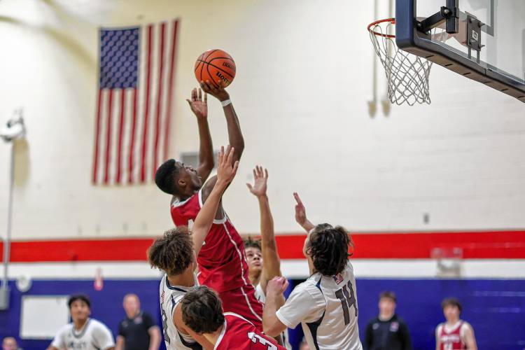Concord’s Alain Twite (4) goes up for a shot while being closely guarded during the Capital Classic boys’ championship game against Merrimack Valley on Friday at John Stark Regional High School in Weare. Twite scored a game-high 21 points to be named the Tournament MVP as Concord defeated MV, 58-46.