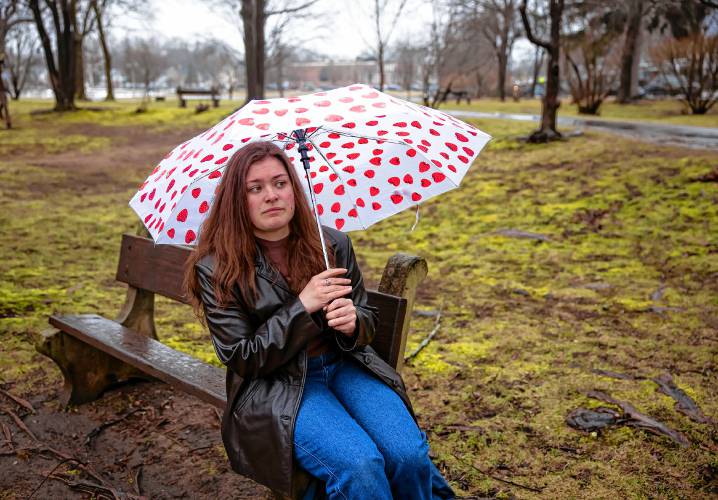 Teegan Paul sits on a bench at White Park on Thursday. Paul is suing the Boys and Girls Club in Concord and Executive Director Chris Emond, accusing the organization of failing to enforce its own policies and reporting sexual abuse.