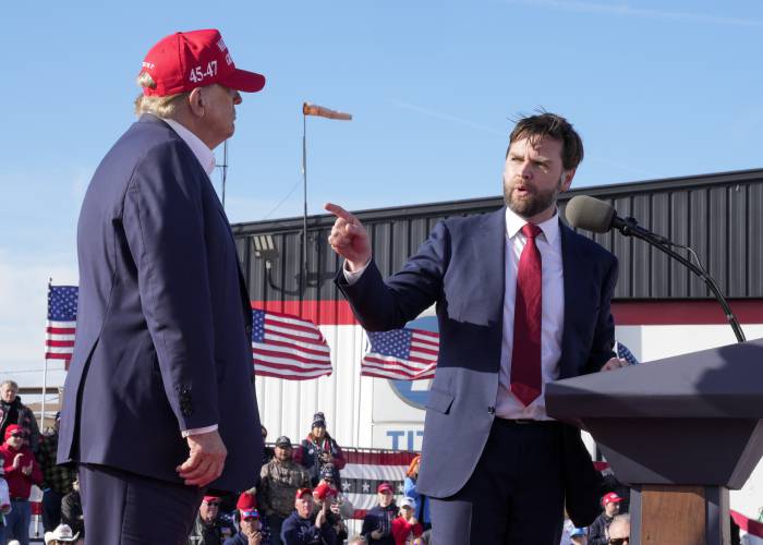 FILE - Sen. J.D. Vance, R-Ohio, right, points toward Republican presidential candidate former President Donald Trump at a campaign rally on March 16, 2024, in Vandalia, Ohio. Vance sharply criticized Trump during the 2016 election cycle, before changing course and embracing the former president. Vance is now one of Trump's fiercest allies and defenders and among those short-listed to be Trump's vice presidential pick. AP Photo/Jeff Dean, File)