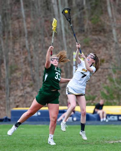 Senior Sydney Westover (left) jumps for a ball against Bow’s Kylie McKee. Westover scored four goals for the Hawks while McKee got three for Bow.